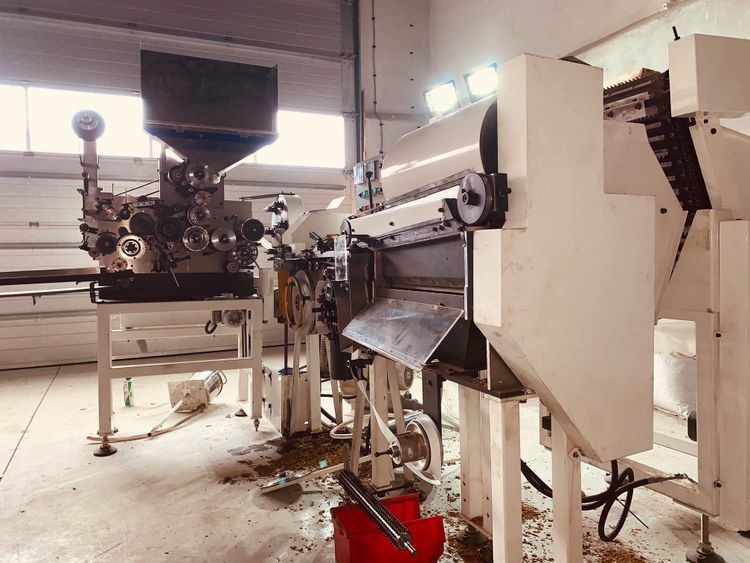 8  Cigarettes making machines, tobacco rod rolling. Small factory.
