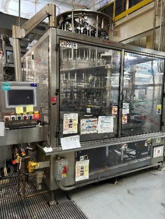 Barry Wehmiller PC-900 Pneumatic Scale Capper (2004) Currently running approximately 300-BPM.