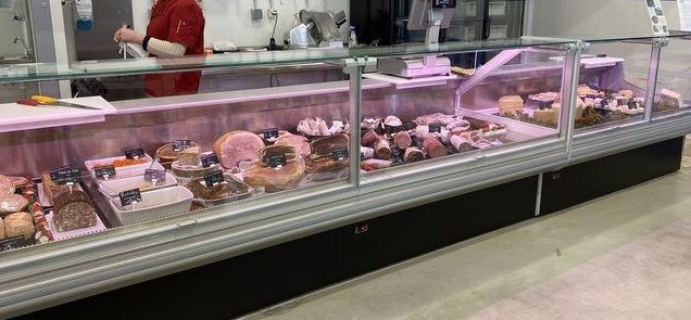 SEDA refrigerated display case presenting meat