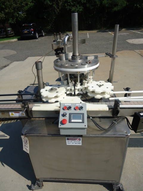 MRM Versafil, Twelve Spout Rotary Positive Displacement Filler With Conveyor