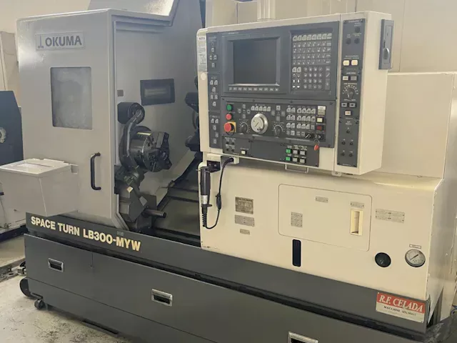 Okuma OSP     Model: E100L 5000 rpm 1/MIN SPACE TURN LB 300 MYW 3 Axis