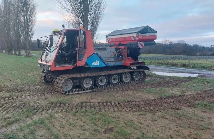 modified snow groomer for spreading fertilizer