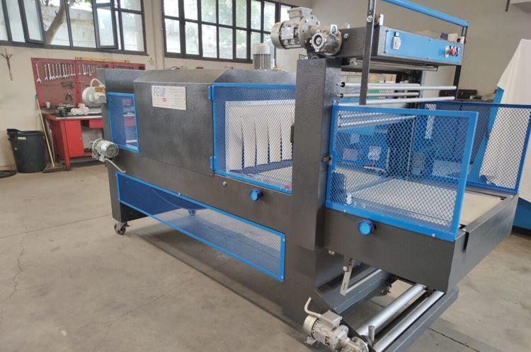 MacDue packaging machine with heat-shrink oven.